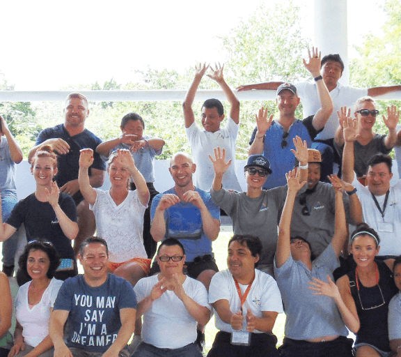 group photo of Allegis Group employees and APAFHDEM members smiling and cheering